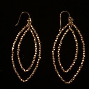 Gold dangle earrings.